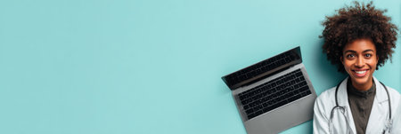 Cheerful young woman sits beside a laptop, radiating positivity in a calm workspace with bright blue accents.の素材