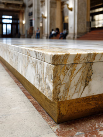 Close-up of a polished marble surface with gold trim, showing intricate patterns and textures in a grand space.の素材