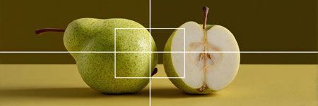 Two green pears on a yellow background, one whole and one halved to showcase freshness and detail.の素材