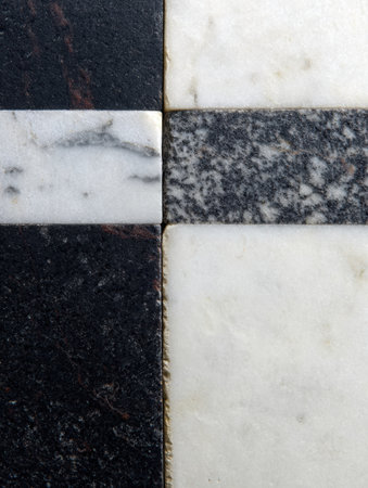 Close-up of marble tiles in black, white, and gray hues arranged in an appealing geometric pattern, adding styleの素材