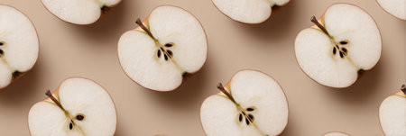 Sliced apples create an appealing pattern, highlighting their smooth surface and seeds against a soft beige backdrop.の素材