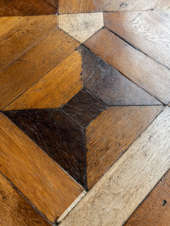 Close-up view of a distinct wooden parquet floor with various shades and patterns, emphasizing craftsmanship and design.の素材