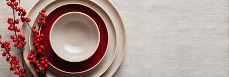 Dishes arranged neatly on a table with vibrant red berries, creating a warm atmosphere for a festive fall event.の素材