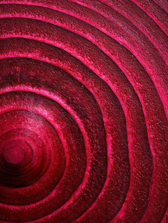 Swirling red patterns form concentric circles with a smooth texture, creating a captivating look of depth and color.の素材