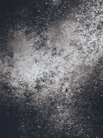 Scattered white particles create an abstract pattern against a dark background, showing unique textures and depth.の素材