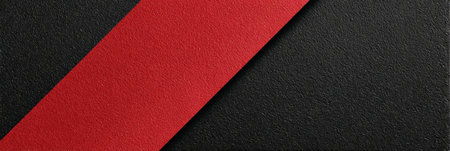 A bright red stripe runs diagonally across a black textured surface. The colors create strong contrast and sharp lines.の素材