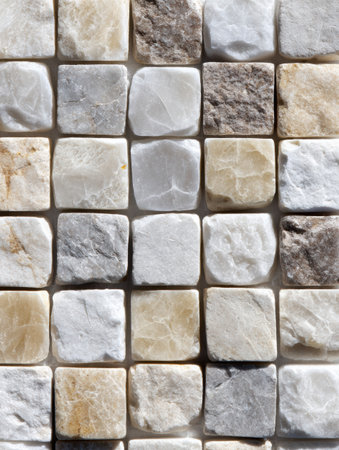 Close-up of neatly arranged square stones, highlighting their textures and colors for decorative use.の素材