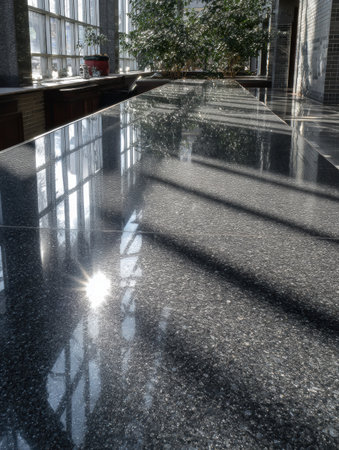 Sunlight reflects off a polished stone surface in a modern interior space, creating a tranquil and inviting atmosphere.の素材