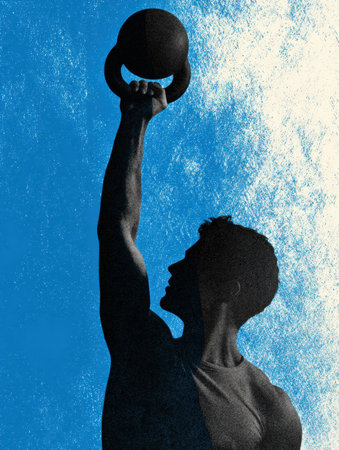 A strong person lifts a kettlebell against a bright blue backdrop, showing strength and determination.の素材