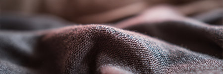 A detailed view of fabric highlighting its texture and colors under soft lighting, creating an interesting visual effect.の素材