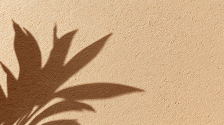 Soft shadows of leaves dance on a smooth wall, capturing a peaceful moment in a cozy indoor space.の素材