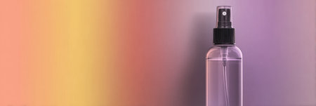A transparent spray bottle is set against a clean gradient background, ideal for modern pharmacy promotional materials and product displays.の素材
