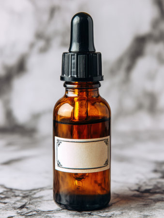 A serum dropper bottle sits on a polished marble surface, featuring a simple and minimal label, enhancing its elegant style.の素材