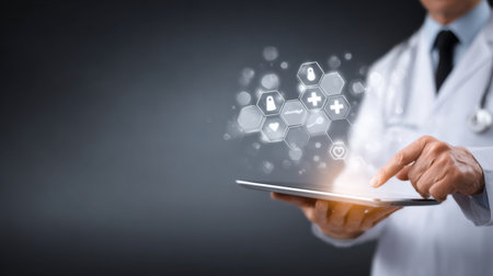 A doctor in a clinical environment interacts with a tablet that shows glowing health icons, highlighting advances in digital medicine.の素材