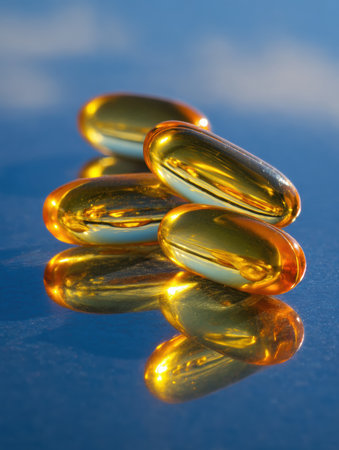 Brightly colored vitamin capsules rest on a reflective glass surface, capturing sunlight in a serene environment.の素材