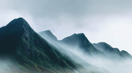 Mist shrouds the mountain peaks, fostering a serene environment that inspires calmness and introspection as nature unfolds its beauty.の素材