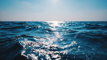 The sun reflects on the gentle ocean waves, creating a serene atmosphere perfect for peaceful moments and reflection.の素材
