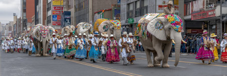 Colorful procession showcases elephants adorned with flowers, accompanied by joyful musicians and dancers in vibrant costumes celebrating culture.の素材