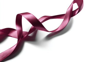 A single, elegant ribbon curl rests gracefully on a blank white surface, showcasing a minimalist approach for luxury Valentineの素材