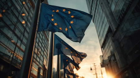 Flags of the European Union wave gently in the city as the sun sets, casting a warm glow that symbolizes unity and celebration of Europe Dayの素材