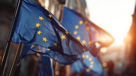 Flags of the European Union wave gently in the evening light as the city honors Europe Day with a warm and festive atmosphere.の素材