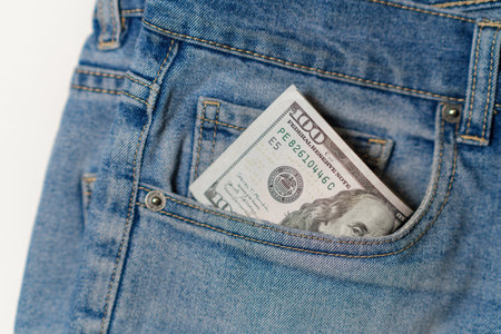Money Tucked Into the Back Pocket of Blue Denim Jeans Ready for a Shopping Trip or Everyday Expenses