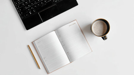 Workspace shows an open notebook, a keyboard, and a coffee mug on a white desktop during the day. The setup invites focus for work or writing tasks.の素材