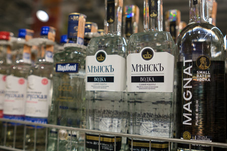 Bottles of Vodka Displayed on a Shelf in a Store During a Busy Shopping Day in a City Locationのeditorial素材