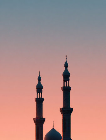 Mosque silhouette stands out against a pastel sky during sunset, capturing a serene moment as daylight fades away.の素材