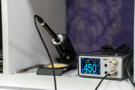 November 25, 2025, Moscow, Russia. Display of a Soldering Station and Tools in a Workspace Showing the Temperature Reading and Equipment Setup for Electronic Projectsのeditorial素材