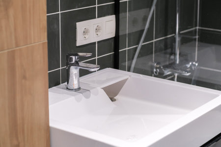 Modern Bathroom Sink Design With Chrome Faucet and Tiled Wall, Showing Clean Lines and Functional...