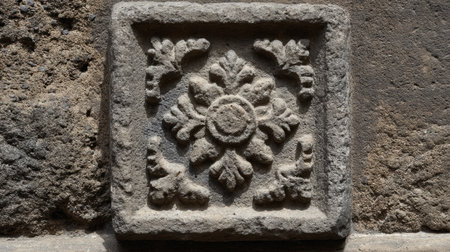 Crafted stone ornament features worn relief details, showcasing the skill of artisans in an ancient city.の素材