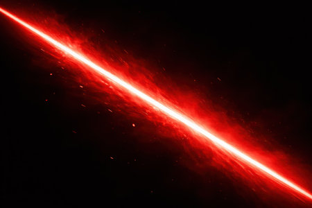 A bright red laser beam cuts through the dark background, surrounded by small particles giving a sense of motion and energy in the scene.の素材