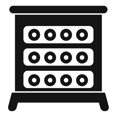 Graphic icon depicting a chest of drawers in a simple black and white silhouetteのイラスト素材