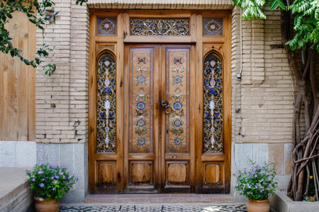 Vintage wooden door with decorative stained glass, set in a brick buildingの素材