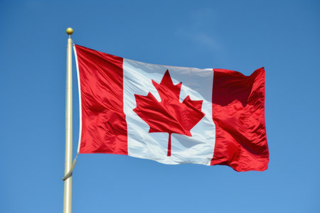 National flag of canada, featuring red and white with the maple leaf, fluttering in the breezeの素材