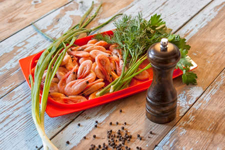 Boiled shrimps with fresh herbs and black pepperの写真素材