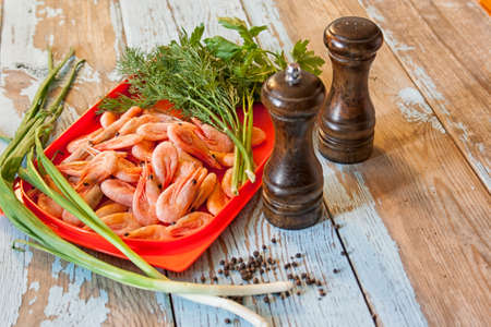 Boiled shrimps with fresh herbs and black pepperの写真素材