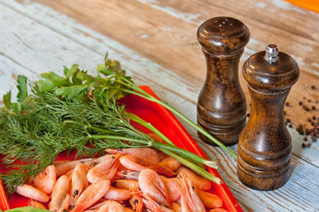 Boiled shrimps with fresh herbs and black pepperの写真素材
