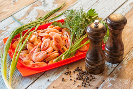 Boiled shrimps with fresh herbs and black pepperの写真素材