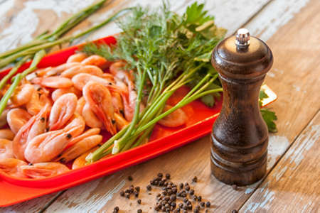 Boiled shrimps with fresh herbs and black pepperの写真素材