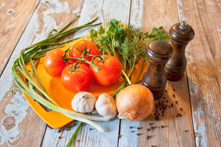 Fresh tomatoes with salad leaves on the table. Background.の写真素材