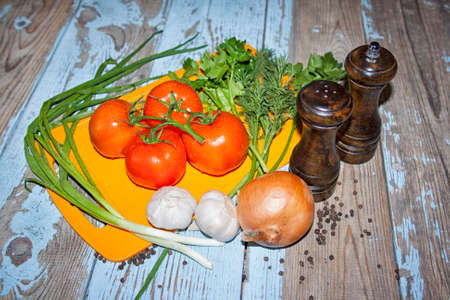 Fresh tomatoes with salad leaves on the table. Background.の写真素材