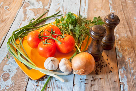 Fresh tomatoes with salad leaves on the table. Background.の写真素材