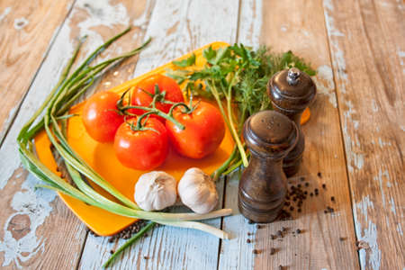 Fresh tomatoes with salad leaves on the table. Background.の写真素材