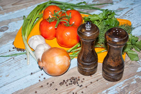 Fresh tomatoes with salad leaves on the table. Background.の写真素材