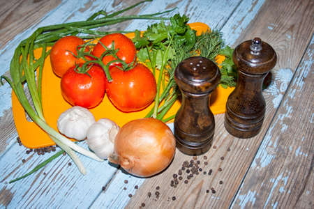 Fresh tomatoes with salad leaves on the table. Background.の写真素材