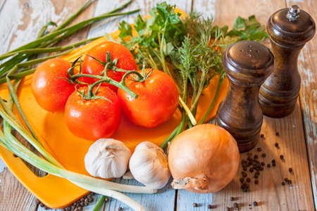 Fresh tomatoes with salad leaves on the table. Background.の写真素材
