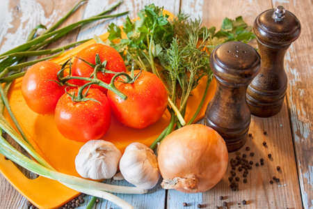 Fresh tomatoes with salad leaves on the table. Background.の写真素材