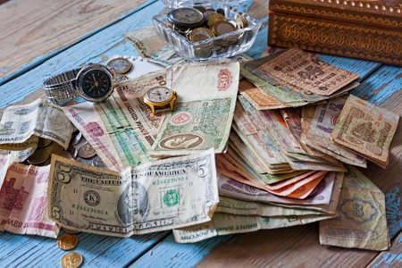 Energy efficiency concept, energy savings and progress. Bulb incandescent lamp and dollars against wooden table, place for text. Concept of energy conservation, green technologyの写真素材